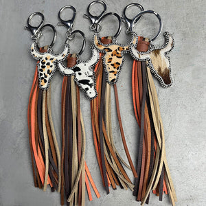 Cowhide horn keychains with fringe tassels in leopard, cow print, and natural hide styles.