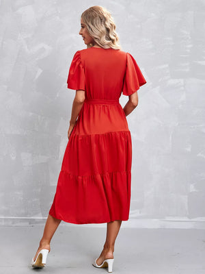 Orange-red tiered midi dress with flutter sleeves and belt