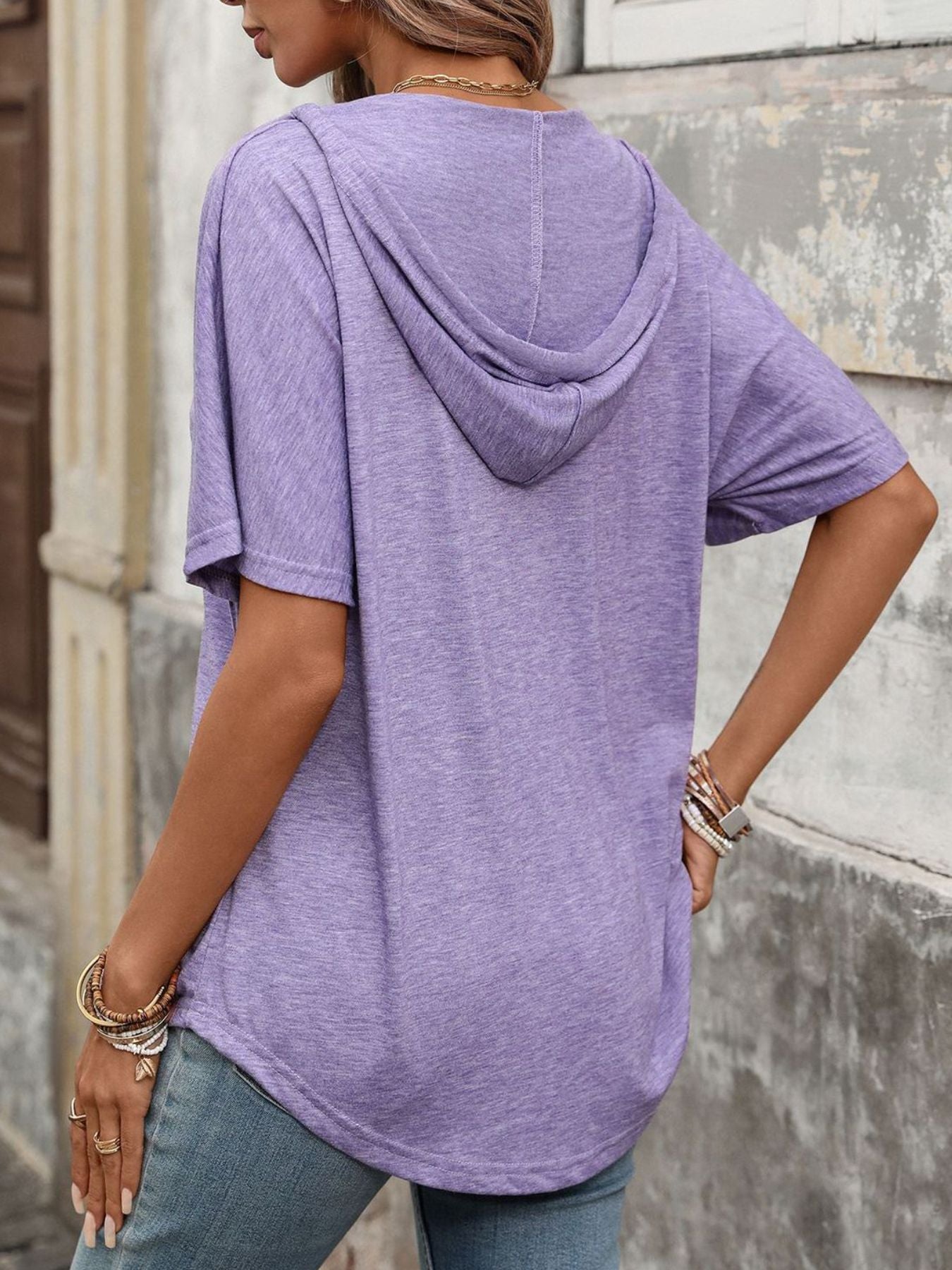 Purple hooded t-shirt with short sleeves and a relaxed fit.