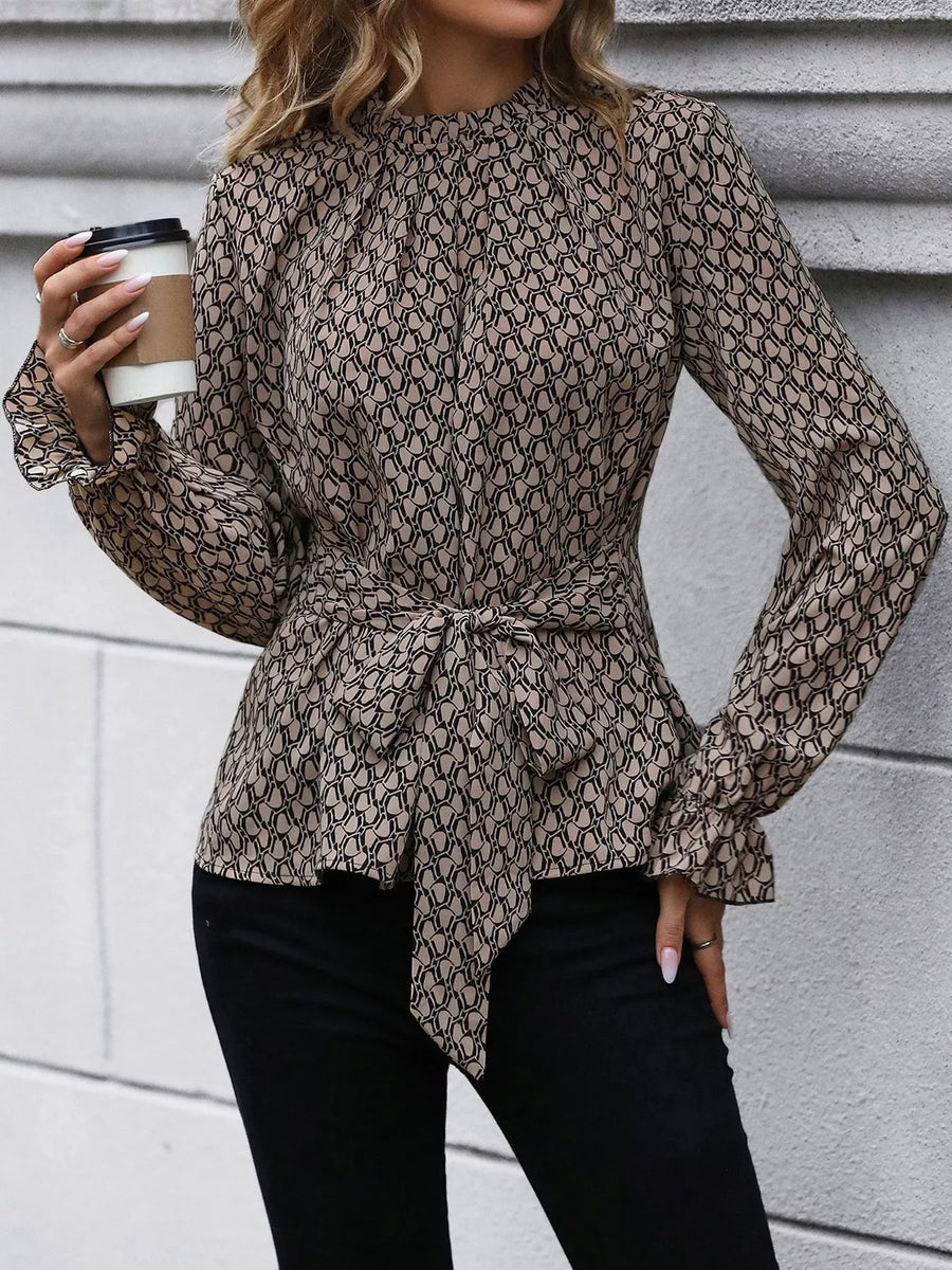 Tied ruffled flounce sleeve blouse in khaki with a geometric print and mock neckline.