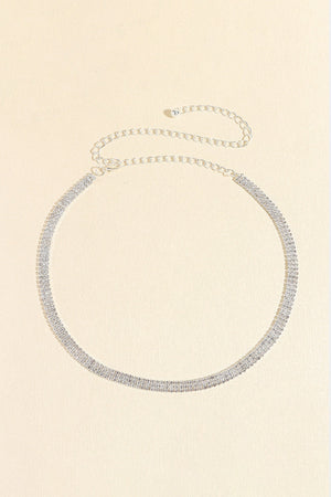 Triple-row crystal waist chain in silver with delicate chain extender.