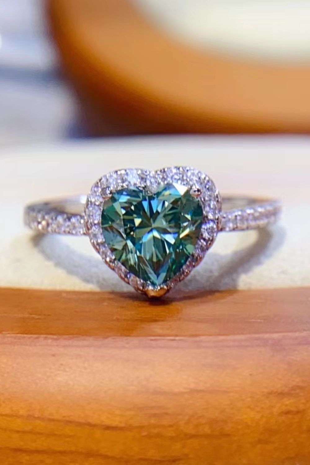 Green heart-cut moissanite halo ring with diamond band