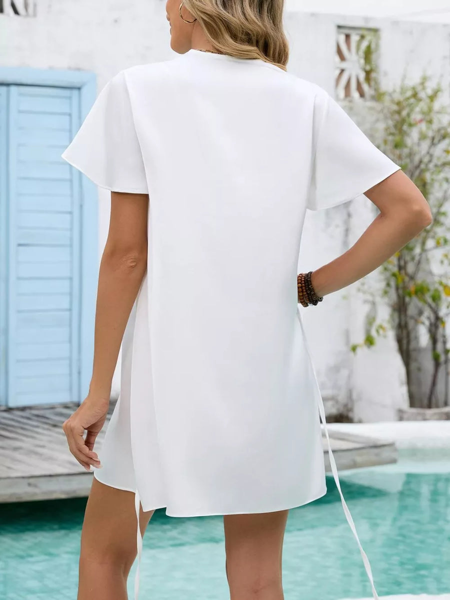 White notched flutter sleeve mini dress with tie detail