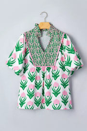 Playful floral v-neck blouse with puff sleeves and green patterned yoke.