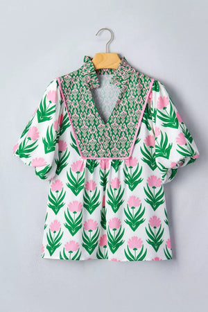 Playful floral v-neck blouse with puff sleeves and green patterned yoke.