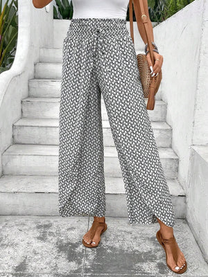 Black and white printed palazzo pants with a drawstring waist and wide legs.