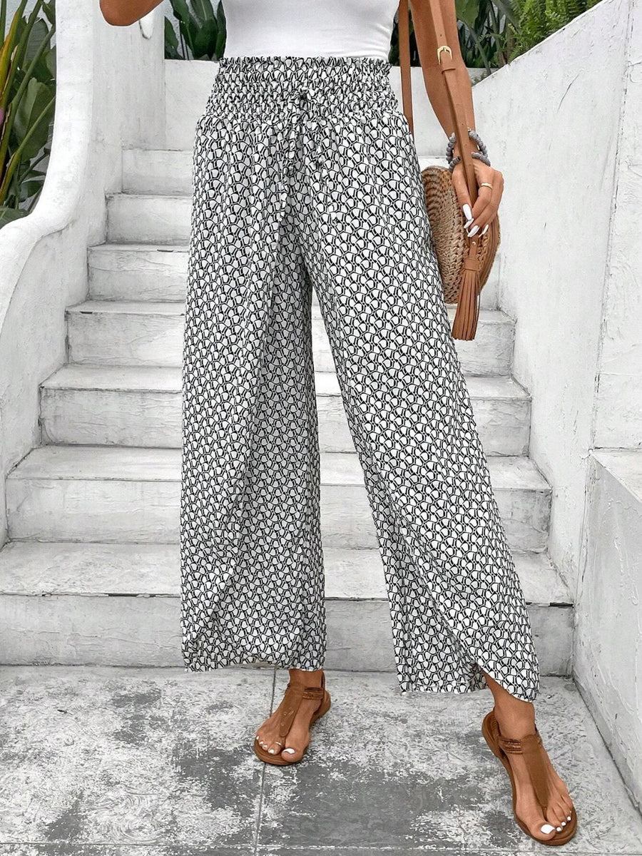 Black and white printed palazzo pants with a drawstring waist and wide legs.