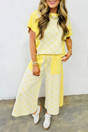 Yellow polka dot cotton blend two-piece set with short sleeves and wide-leg pants.