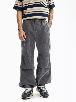Grey relaxed fit cargo pants with elastic waist and layered knee detail.