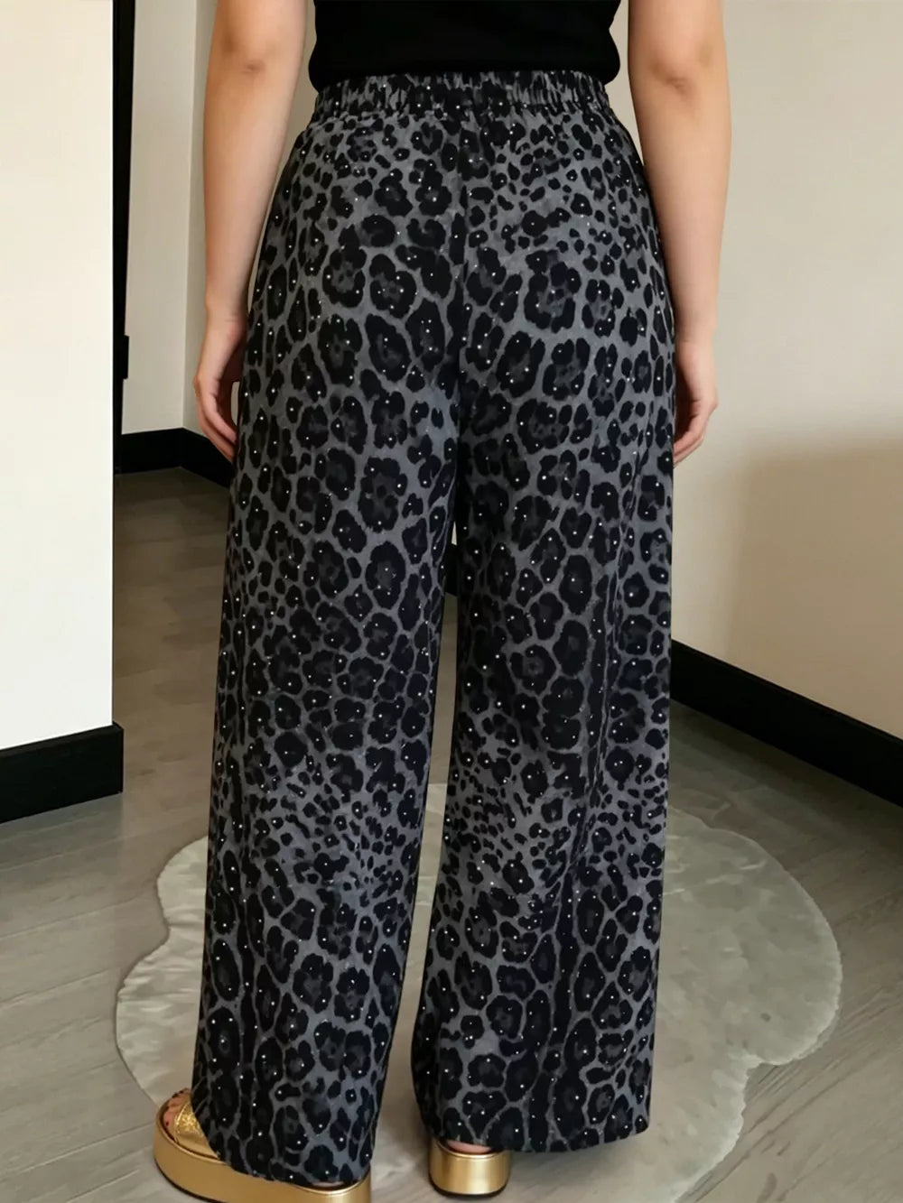 black wide-leg pants featuring drawstring waist and leopard-print