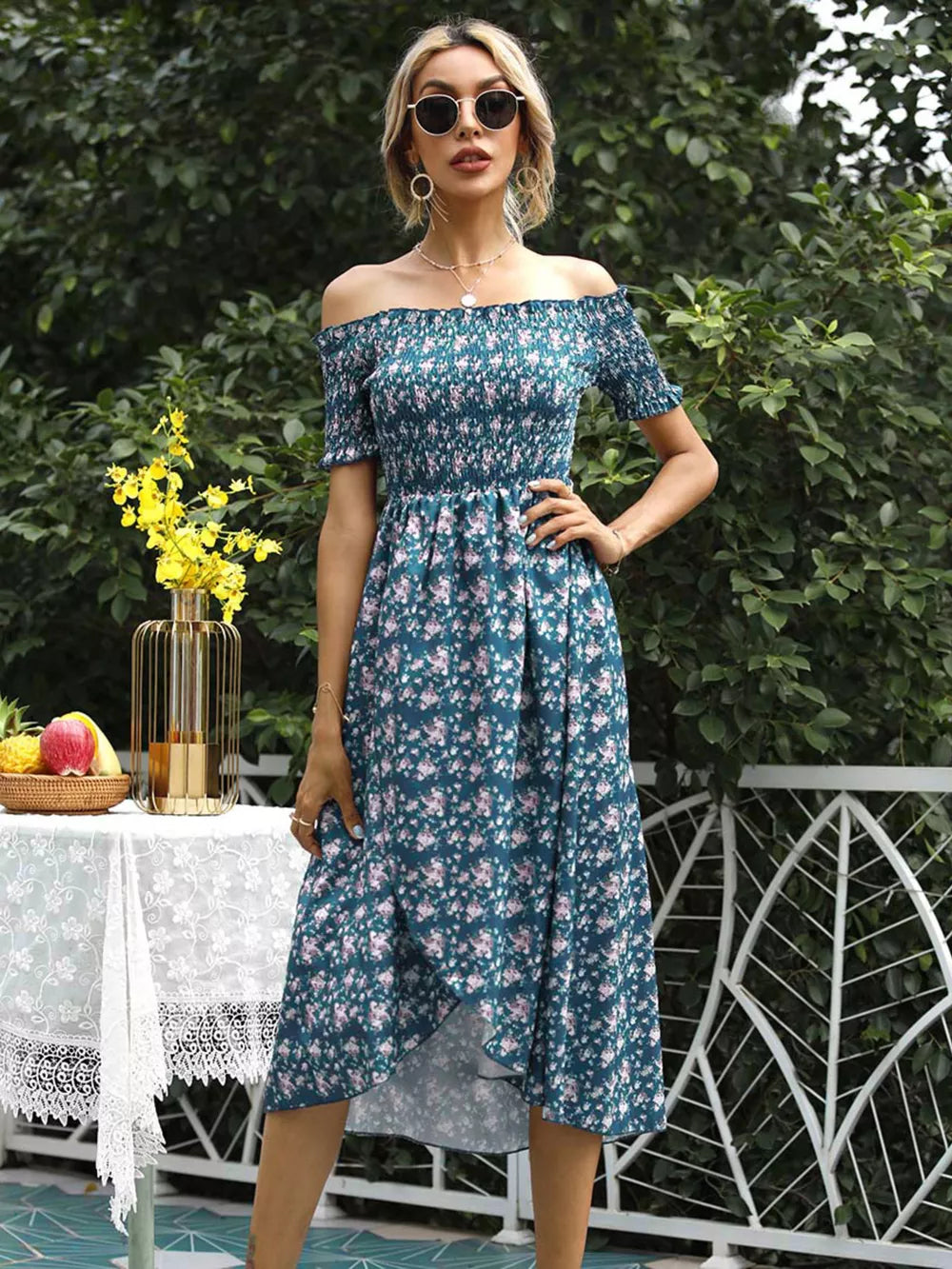 Floral off-shoulder midi dress in deep teal with a ruffled hem and a thigh-high slit.
