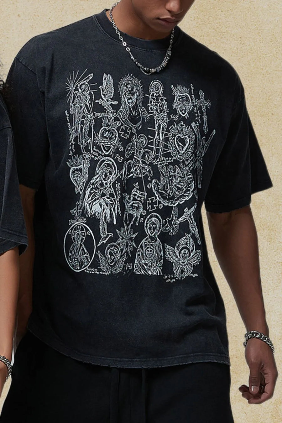 Black vintage wash t-shirt with a detailed religious icon graphic print.