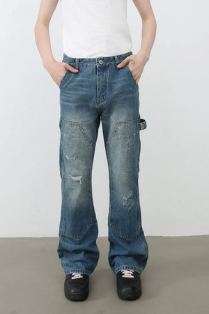 Carpenter flare jeans in medium wash denim with distressed details and a relaxed fit.
