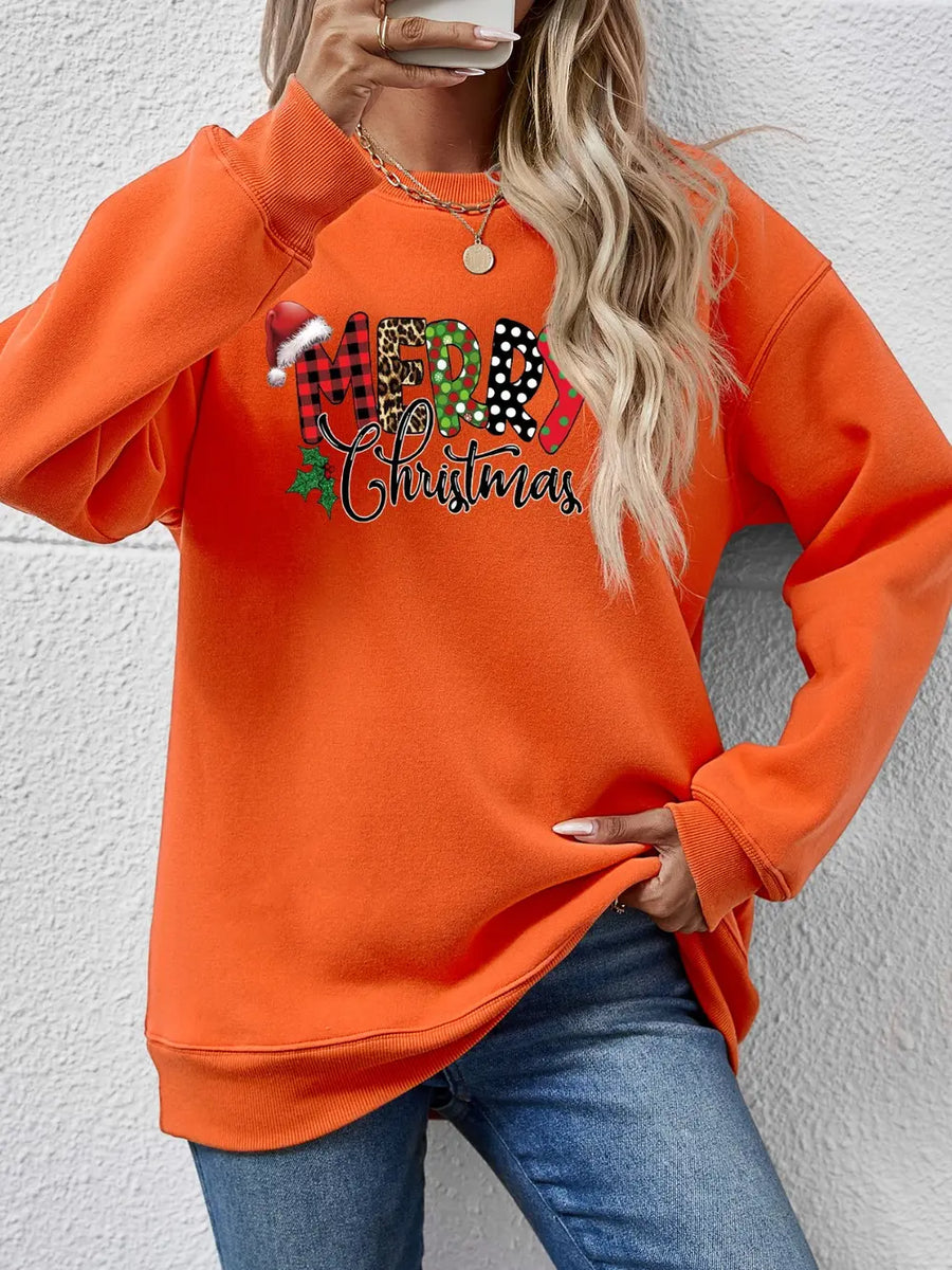 Orange graphic sweatshirt with Merry Christmas text in festive patterns and a drop shoulder cut.