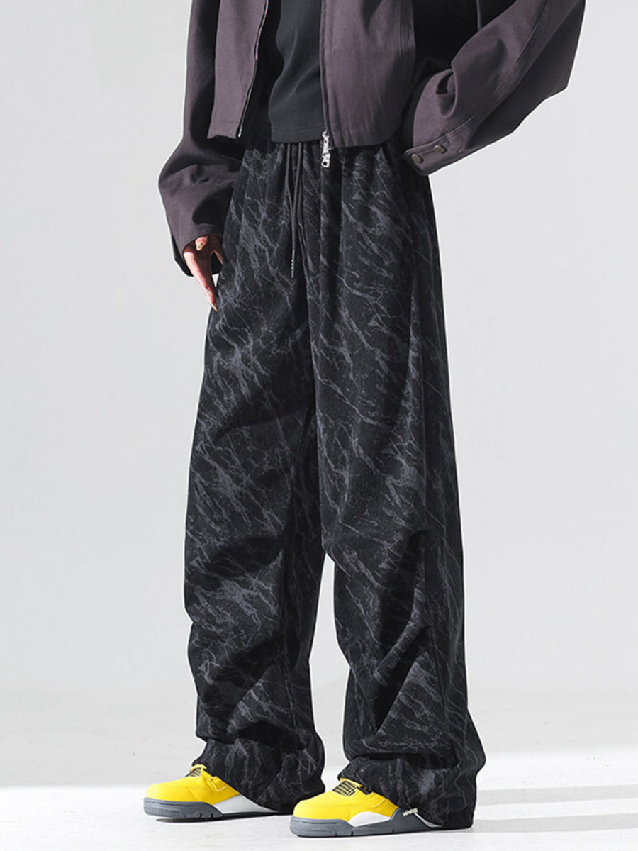 Men's black vintage wide leg sweatpants with marble pattern and drawstring waist.