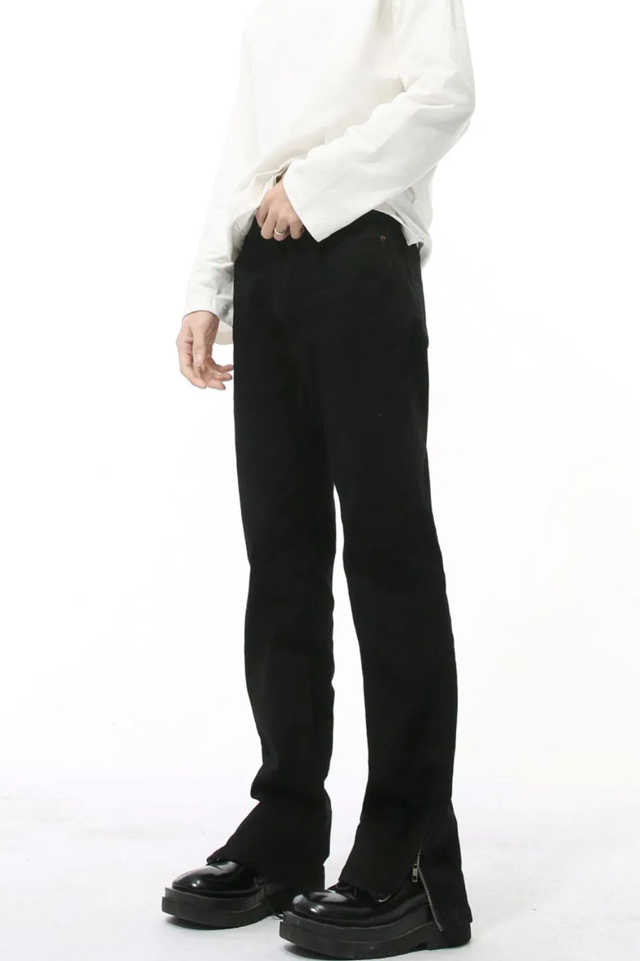 Black denim jeans with split hem and zipper detail