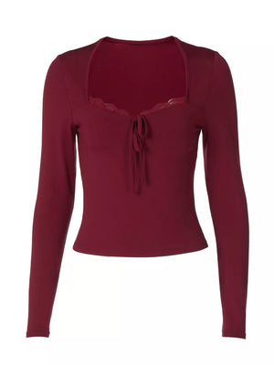 Wine red long sleeve tee with lace trim neckline and tie detail.