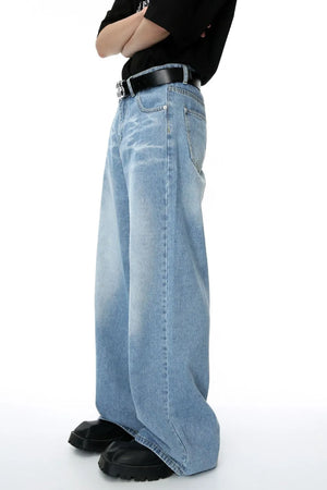 Oversized denim palazzo jeans in medium wash with subtle fading and a relaxed fit.