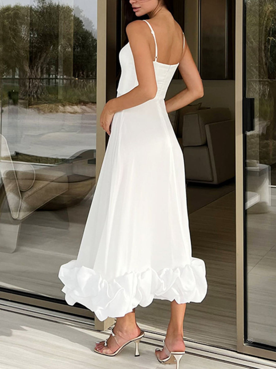 White midi dress with spaghetti straps and a dramatic ruffle hem.