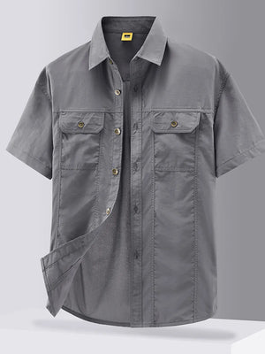 Grey short-sleeve button-down shirt with two chest pockets and cotton fabric.