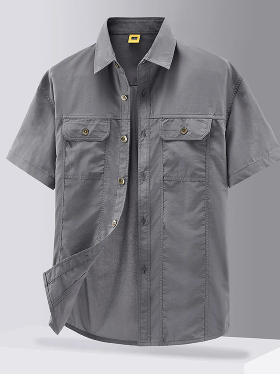 Grey short-sleeve button-down shirt with two chest pockets and cotton fabric.