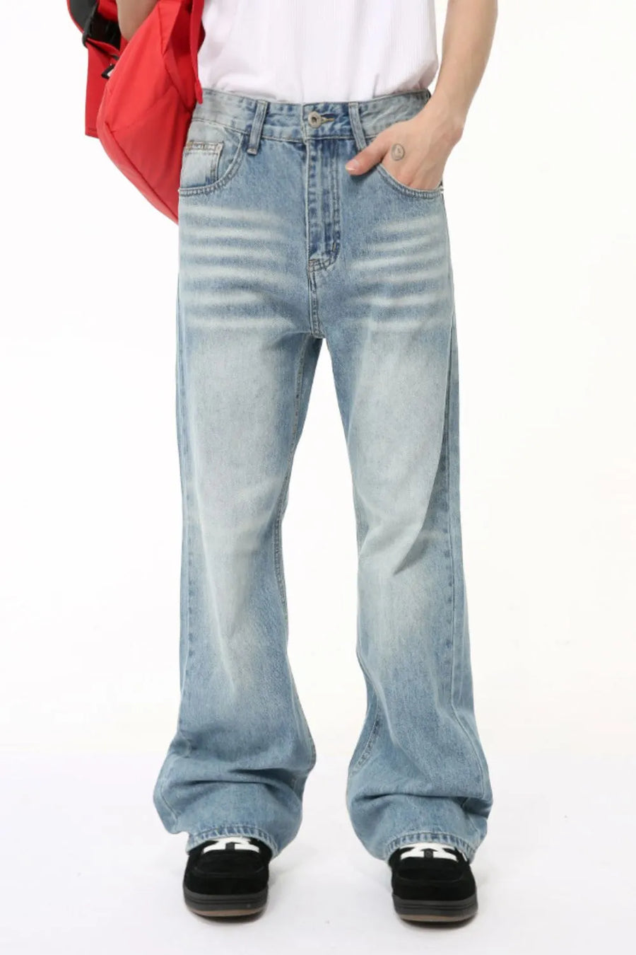 Wide leg washed denim trousers in medium blue with a relaxed fit and subtle whiskering.