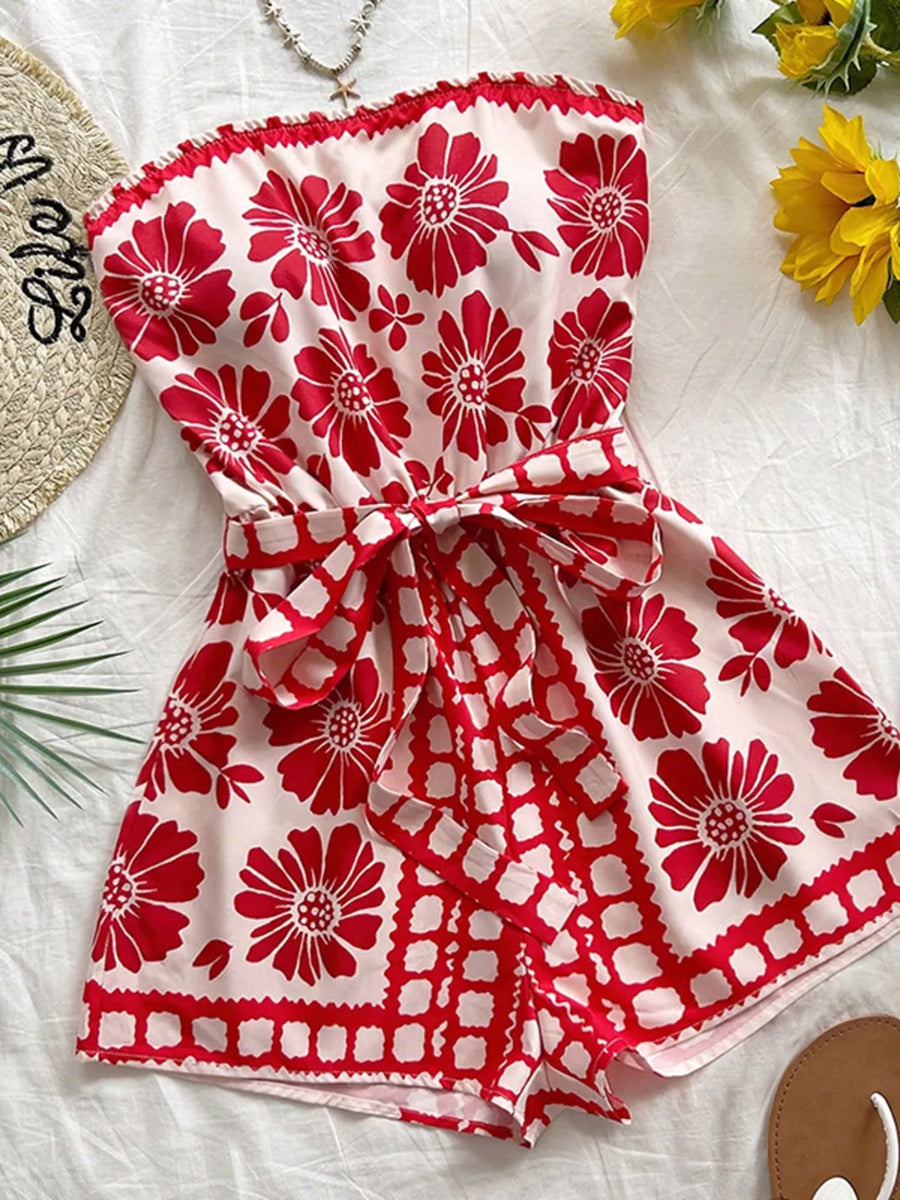 Red floral tie-waist strapless maternity romper with ruffled hem and border print.