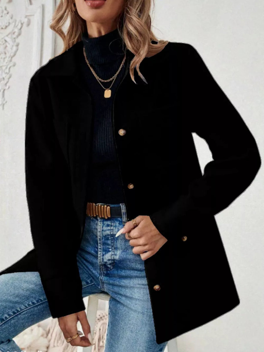 Black button-front trench coat with gold buttons and pockets, styled with jeans.