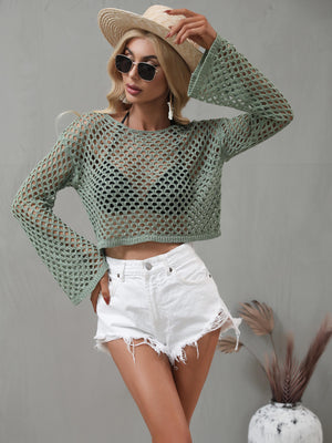 Green open-knit acrylic crop top with bell sleeves worn over a bikini top