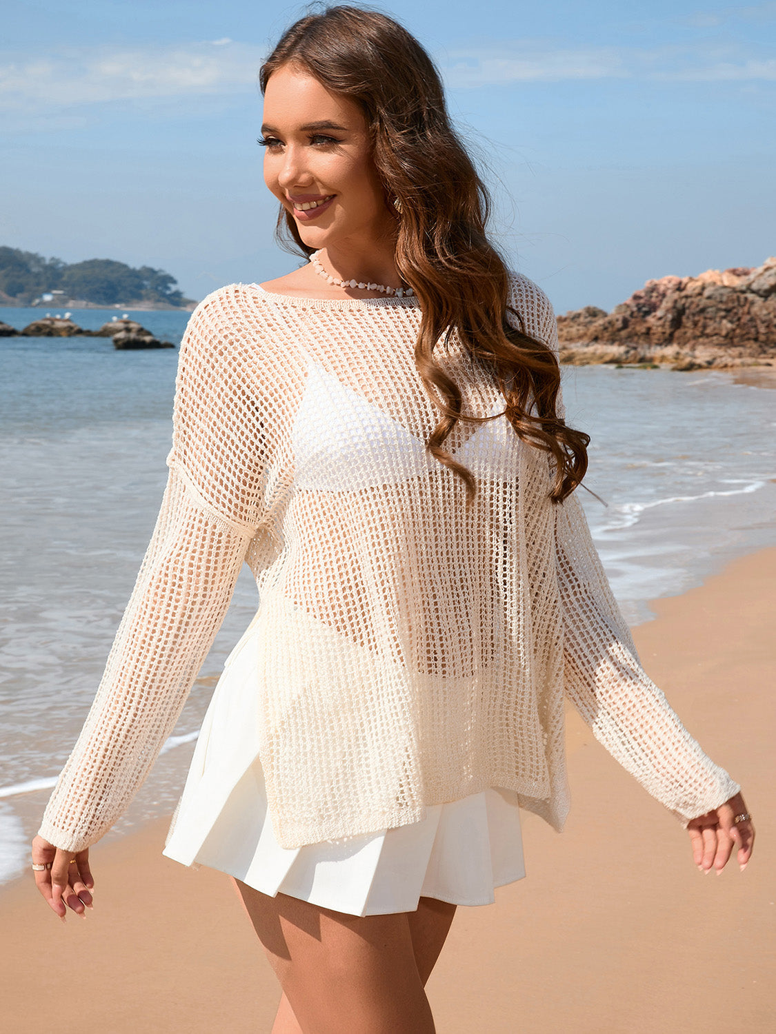 Cream open-knit beach sweater with boat neck and long sleeves, acrylic.