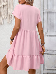 Pink V-neck ruffle hem mini dress with short sleeves and tiered skirt.