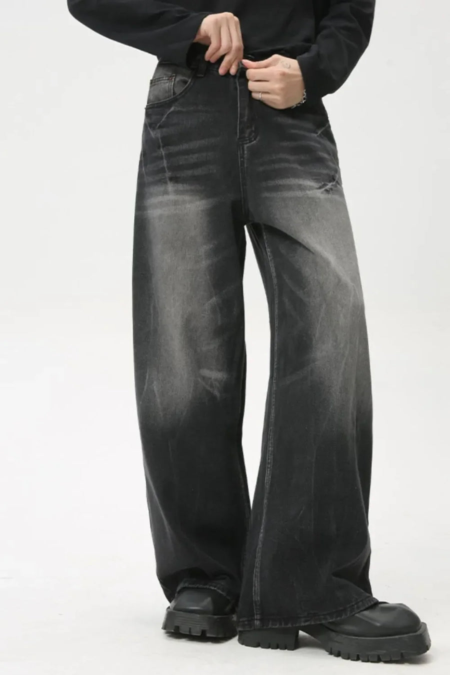 Whiskered wide leg denim jeans in dark wash, featuring a relaxed fit and distressed details.