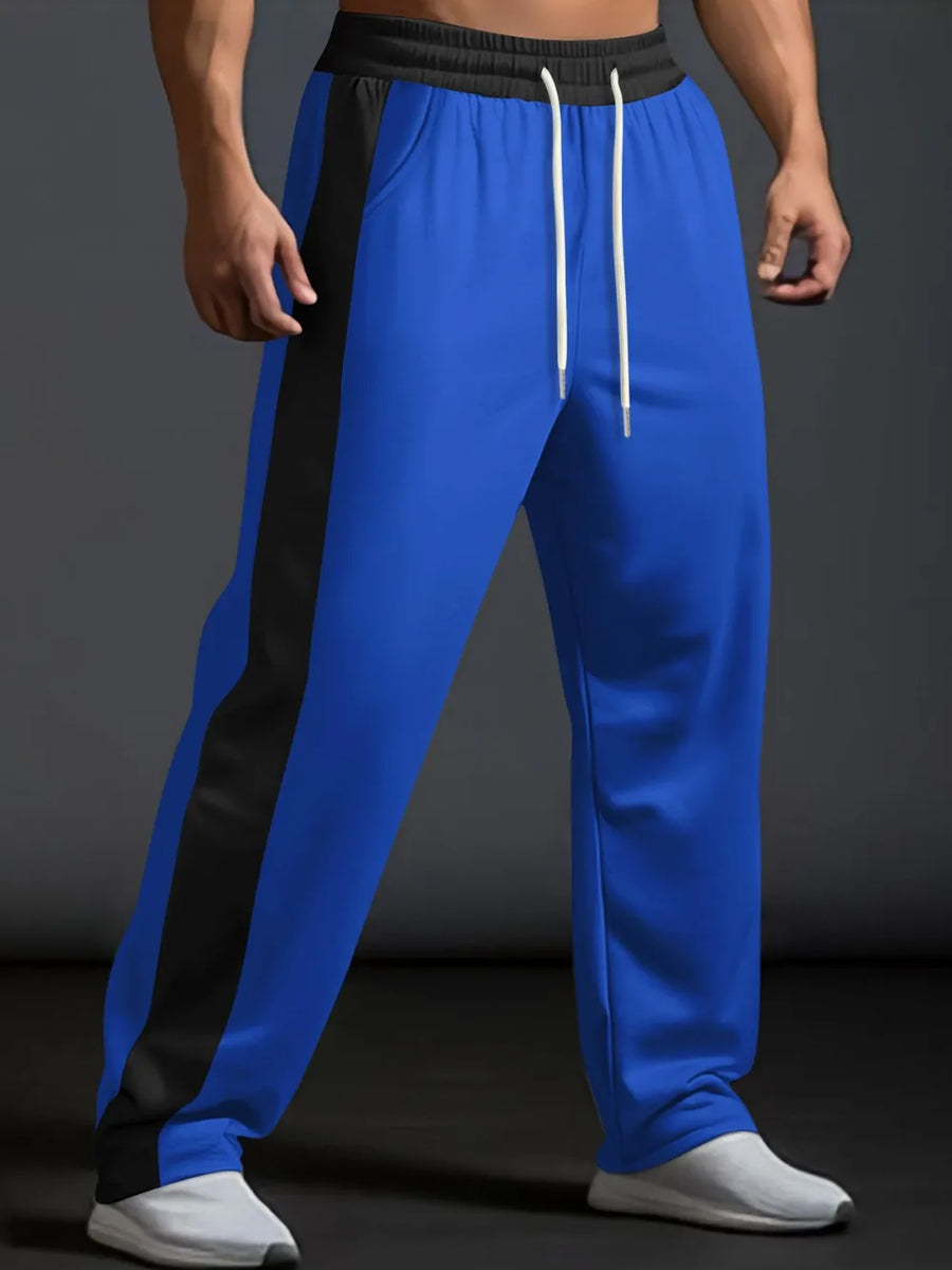 Royal blue track pants with black side panel detail and white drawstring.