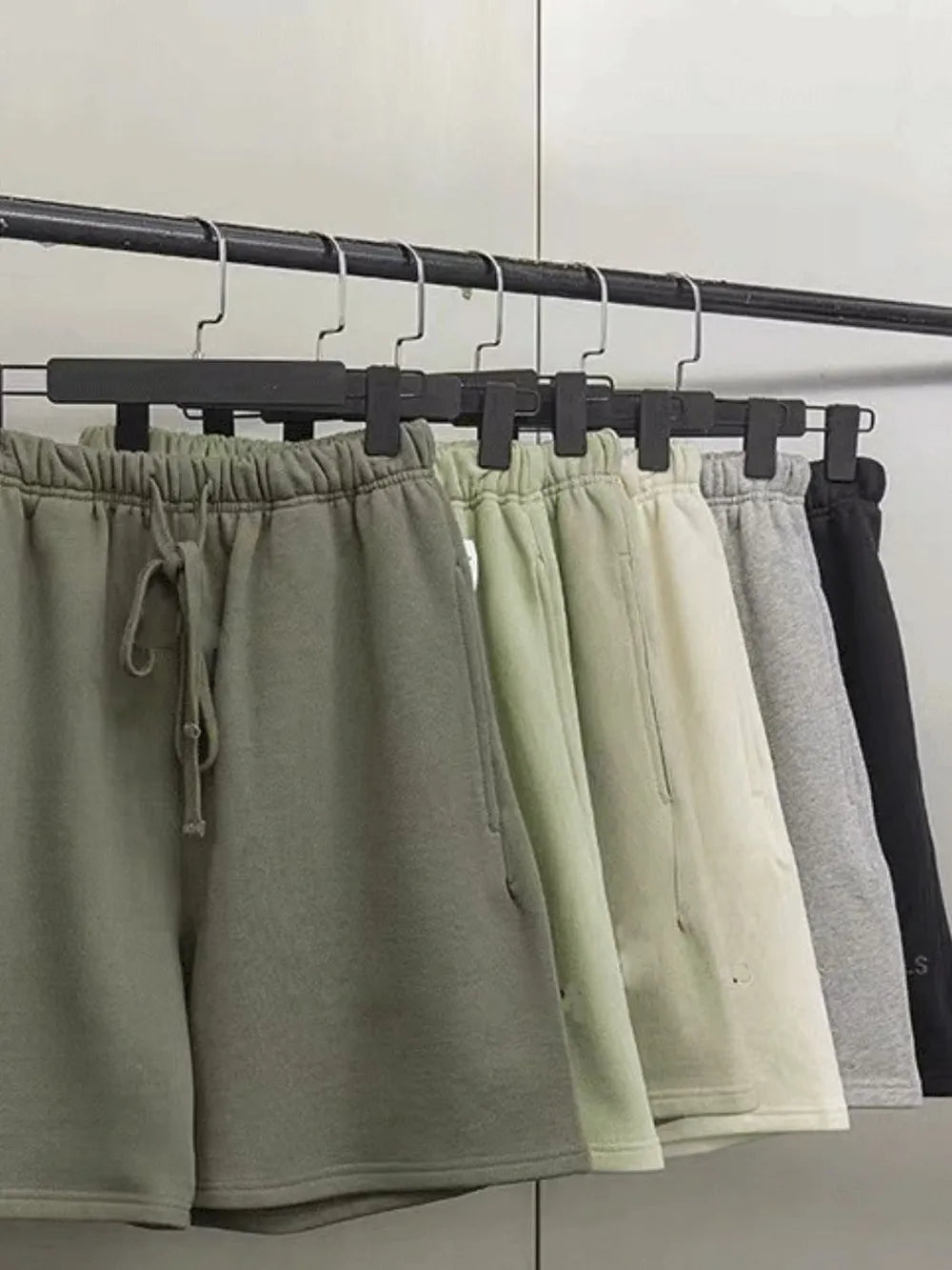 Men's jogger shorts in green, beige, gray, and black with drawstring waist