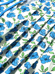 Floral ruffle sleeve tie-neck blouse with blue floral print on white cotton fabric.