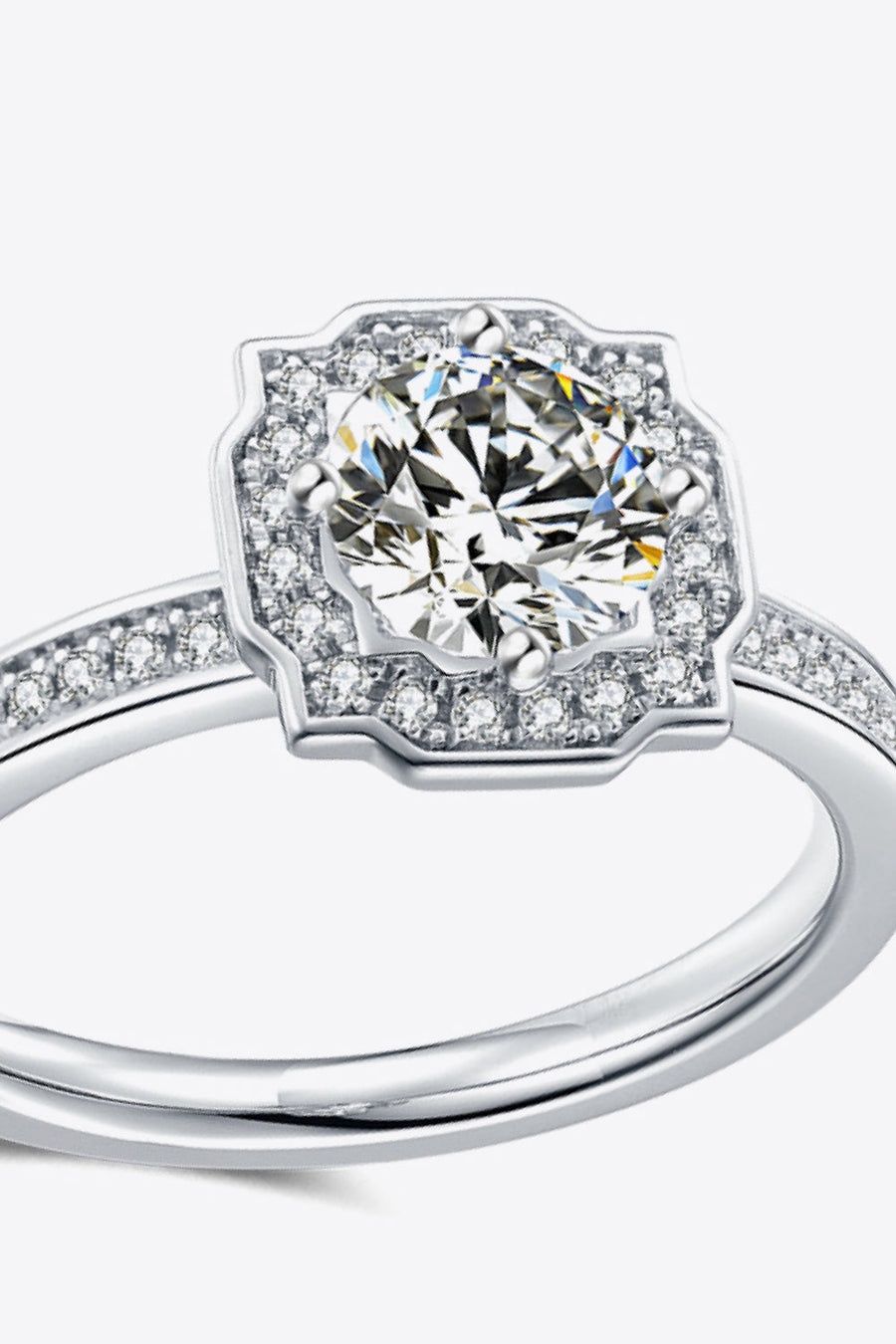 Silver halo diamond engagement ring with pavé band.