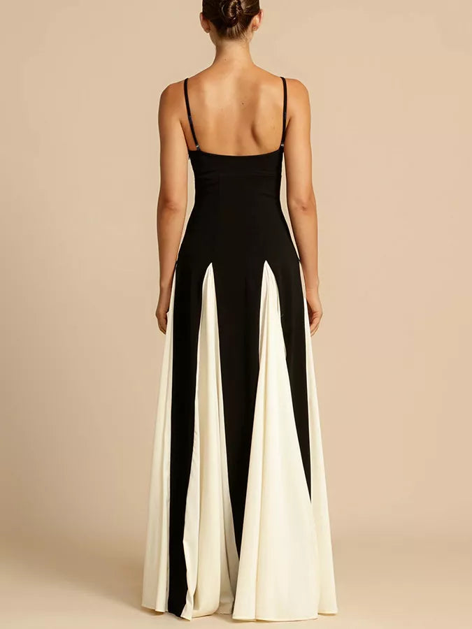 Elegant maxi dress with spaghetti straps in black and white with a flowing skirt.