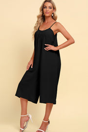 Black culotte jumpsuit with gathered bodice and spaghetti straps.