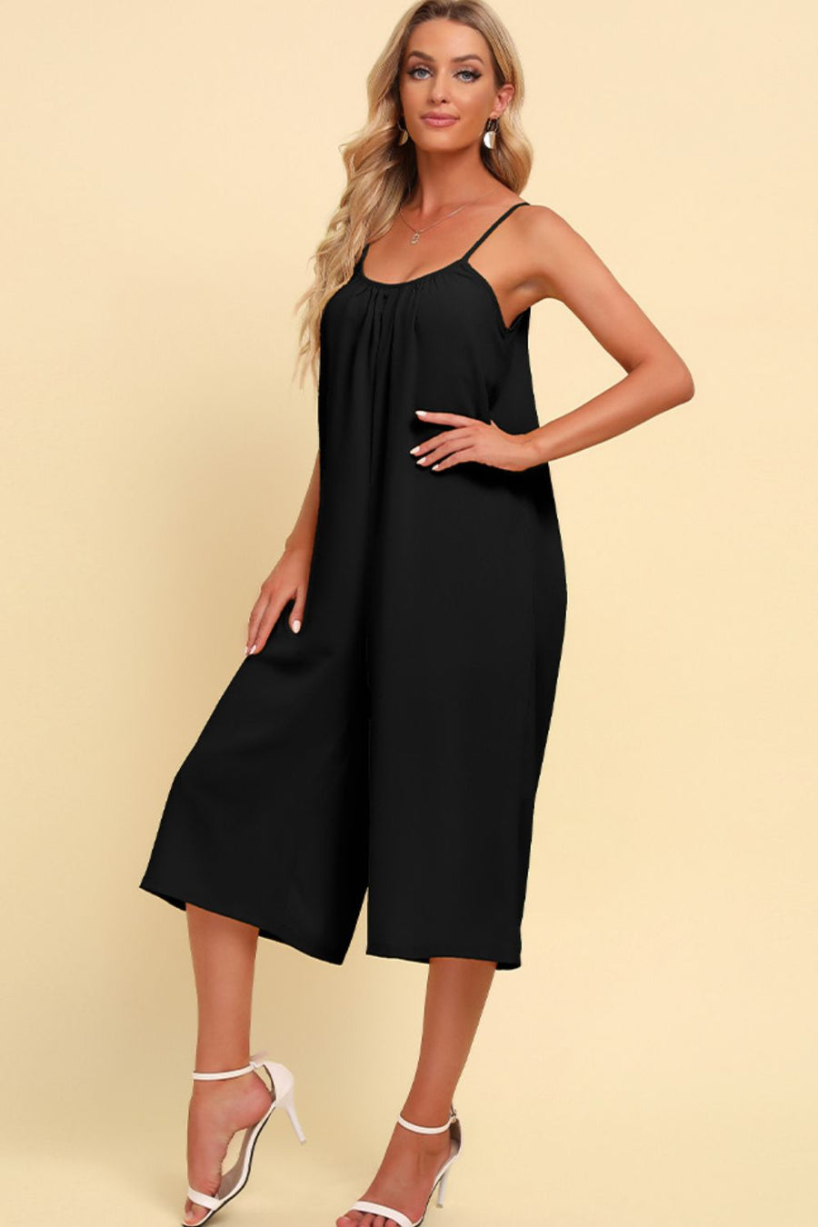 Black culotte jumpsuit with gathered bodice and spaghetti straps.