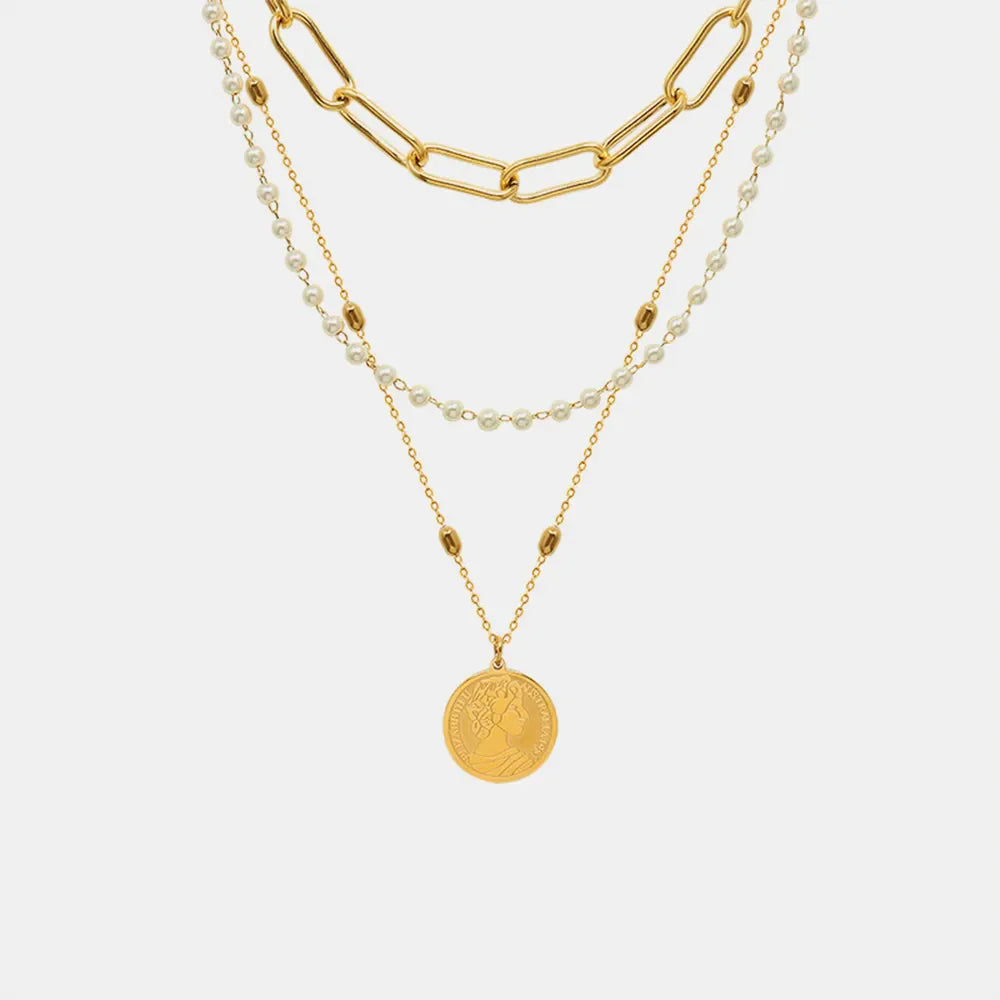 Gold layered necklace with chunky chain, pearls, and coin pendant