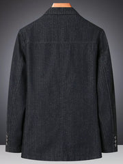 Textured dark blue denim blazer with notched lapels and buttoned cuffs.