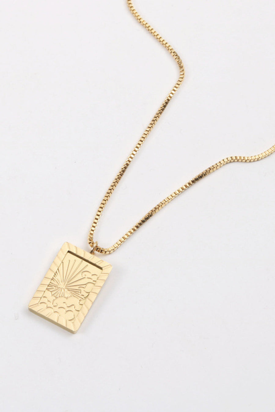 18K gold-plated celestial pendant necklace with sunburst detail on a box chain.