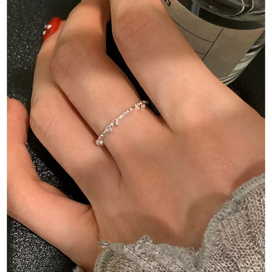 Delicate sterling silver ring with a dainty bow design.