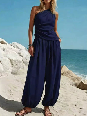 Navy one-shoulder top and wide-leg pants set with ruched detail on top and gathered ankles.