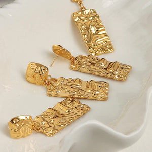 Sculptural gold-plated crinkle earrings with hammered texture and rectangular drops.