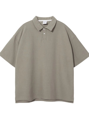 Boxy textured polo shirt in Khaki with short sleeves and a two-button placket.