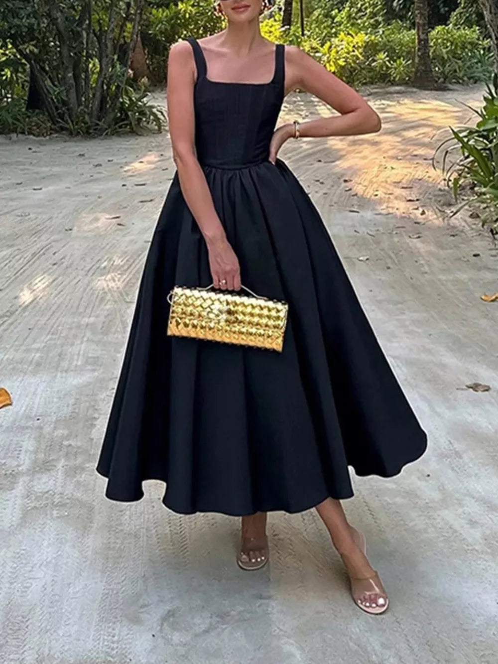 Black square neck a-line midi dress with a full skirt, sleeveless, and fitted bodice.