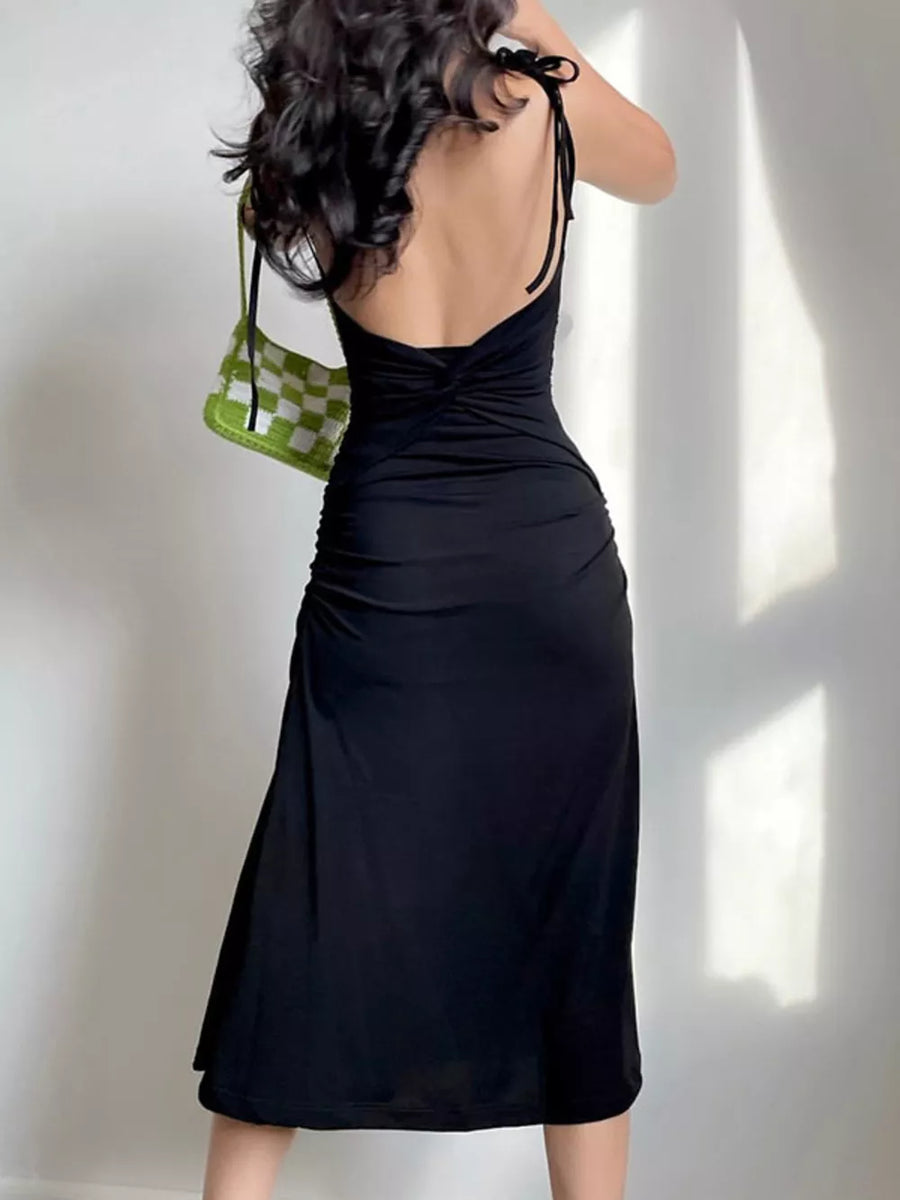 Black ruched midi dress with tie straps and a twisted back detail.