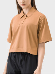 Cropped polo top in beige with short sleeves and a button placket.