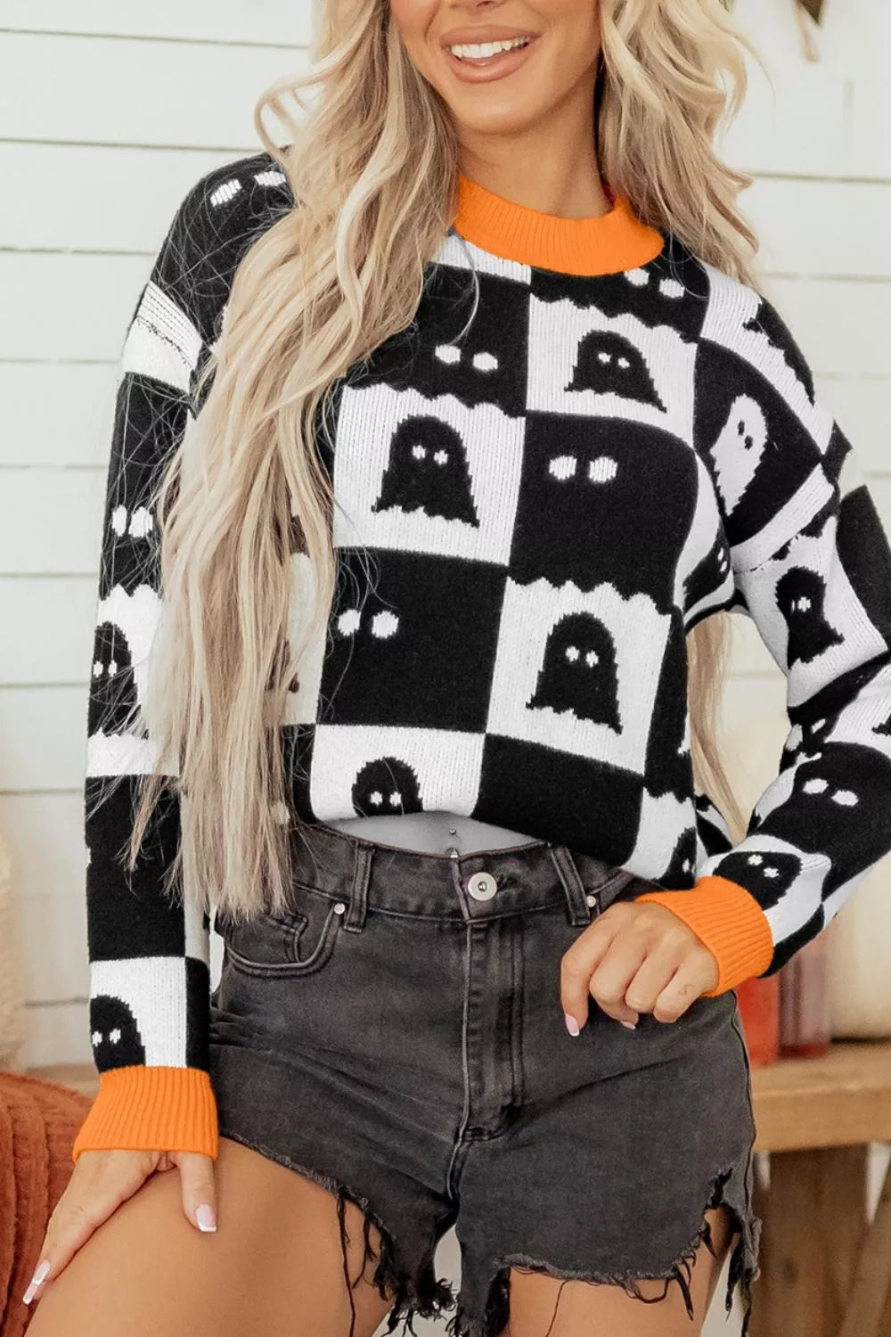 black pullover sweater with checkerboard and crew neck